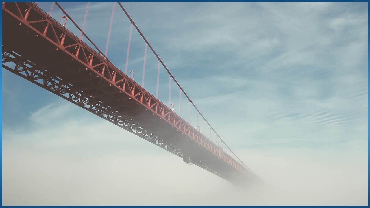 long bridge over cloudy skies
