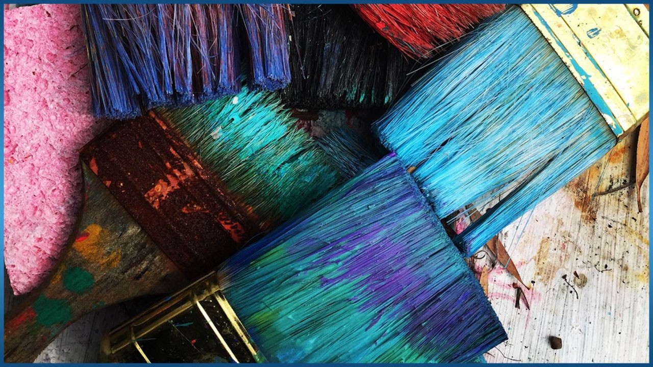 different paintbrushes mixing colors