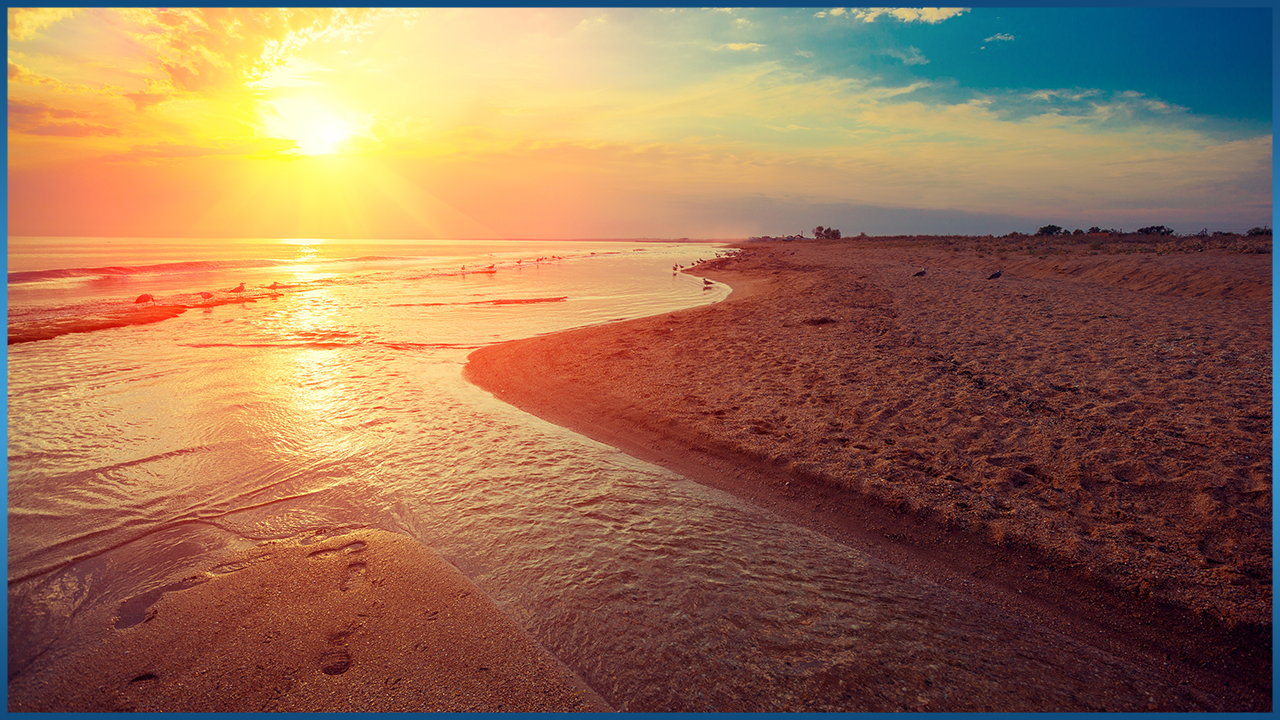 sun setting over beach