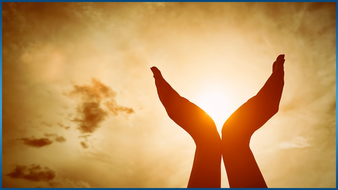 2 hands cupping the shining sun
