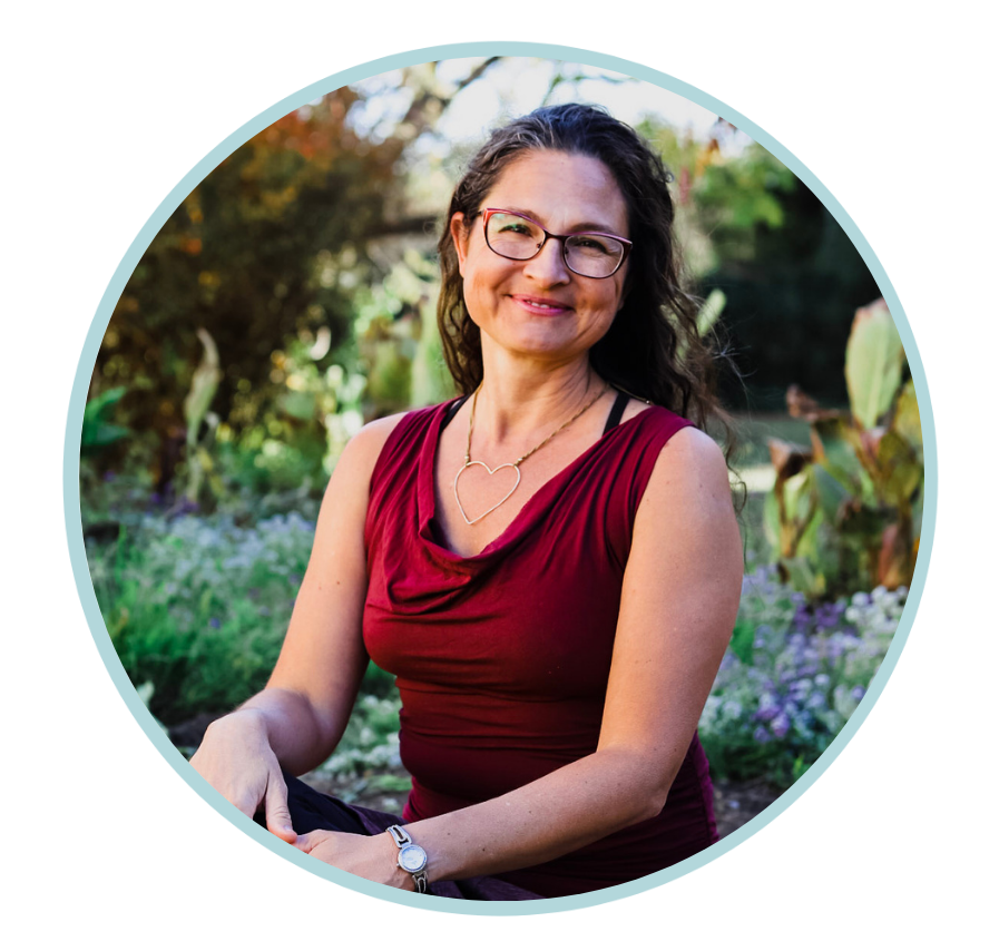 photo of Ky Russell smiling with a garden behind her