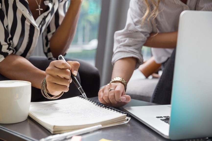 two women collaborate on market research to see what the most profitable product could be to serve their audience