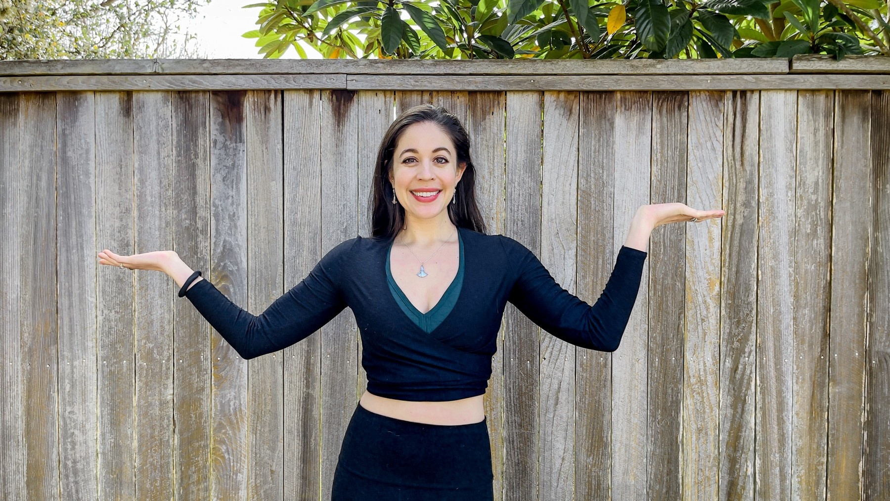 female entrepreneur takes a break mid-day and reclines on the couch, feet in air, experiencing joy