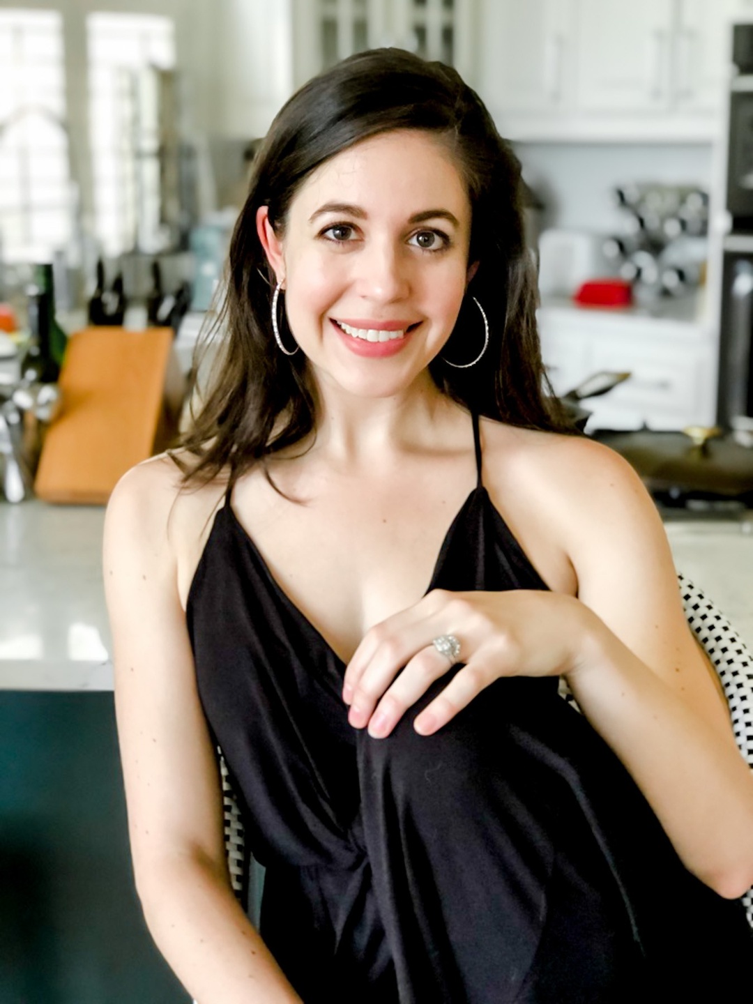 Rachel Loewenherz leans on a chair, chin in hands, with a warm smile—welcoming new entrepreneurs who want to take an idea and turn it into a business that empowers them with the tools to sustain themselves long-term