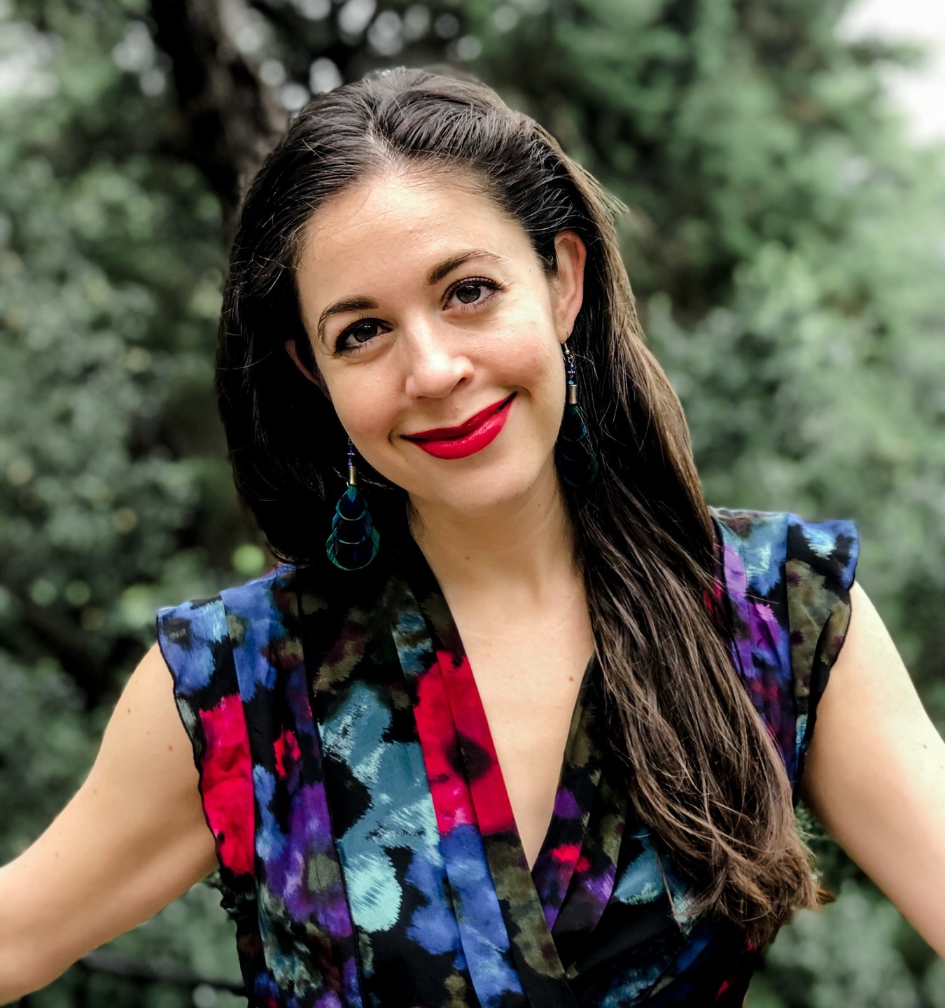Rachel Loewenherz leans on a chair, chin in hands, with a warm smile—welcoming new entrepreneurs who want to take an idea and turn it into a business that empowers them with the tools to sustain themselves long-term
